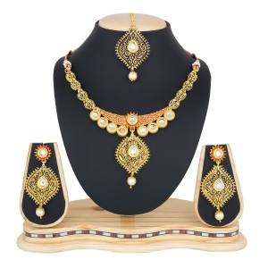 You Will Definitely Earn Lots Of Compliments Wearing This Designer And Elegant Looking Necklace Set In Golden Color Beautified With White Colored Stones. Buy This Rich Looking Necklace Set Now.