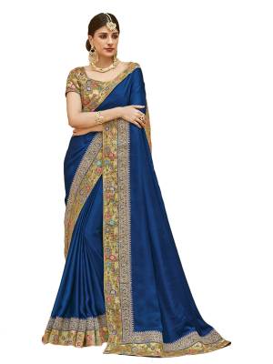 Shine Bright Wearing this Attractive Saree In Royal Blue Color Paired With Golden Colored Blouse, This Saree Is Fabricated In Satin Silk Paired With Art Silk Fabricated Blouse. Its Has Colorful and Embroidered Lace Border. Buy This Designer Saree Now.