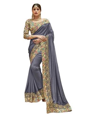 Flaunt Your Rich And Elegant Taste Wearing This Designer Saree In Grey Color Paired With Golden Colored Blouse. This Saree And Blouse Are Fabricated On Art Silk Beautified With Printed And Embroidered Lace Border. Buy Now.