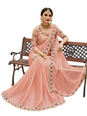 A Must Have Shade In Every Womens Wardrobe Is Here In Peach Color Paired Wih Peach Colored Blouse. This Saree Is Fabricated On Satin Silk Paired With Art Silk Fabricated Blouse. It Has Beautiful Embroidery Over The Blouse And Saree Lace Border. Buy Now.