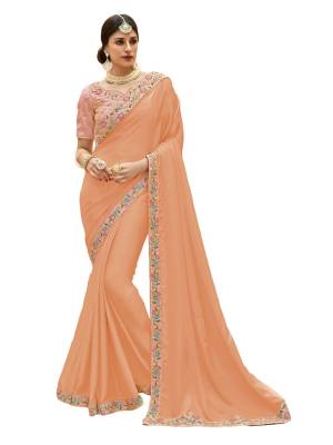 Look Pretty In This Designer Saree In Peach Color Paired With Baby Pink Colored Blouse. This Saree Is Fabricated On Satin Silk Paired With Art Silk Fabricated Blouse. It Is Beautified With Multi Colored Embroidery Over The Blouse And Lace Border.
