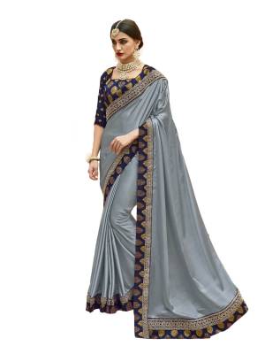 Flaunt Your Rich And Elegant Taste Wearing This Designer Saree In Grey Color Paired With Golden Colored Blouse. This Saree Is Fabricated On Satin Silk Paired With Jacquard Silk  Fabricated Blouse Beautified With Printed And Embroidered Lace Border. Buy Now.