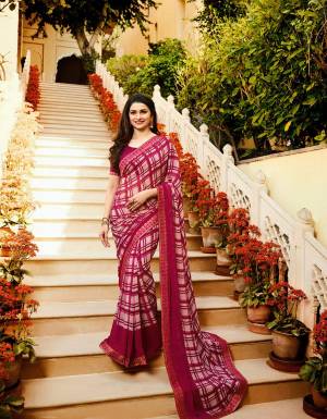Grab This Checks Printed Pretty Saree  In White And Magenta Pink Color Paired With Magenta Pink Colored Blouse, This Saree Is Fabricated On Georgette Paired With Art Silk Fabricated Blouse. Its Bold Checks Will earn You Lots Of Compliments From Onlookers.
