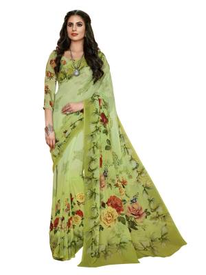 Have A Fresh And Pretty Look Everytime You Wear This Saree In Green Color Paired With Green Colored Blouse. This Saree And Blouse Are Fabricated On Georgette Beautified With Bold Multi Colored Prints All Over It.