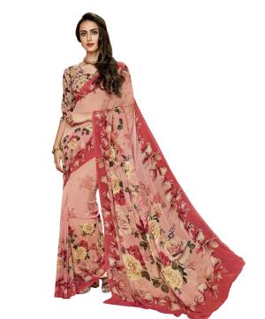 A Must Have Color In Every Womens Wardrobe Is Here In Peach Color Paired With Peach Colored Blouse, This Saree And Blouse Are Fabricated On Georgette Beautified With Bold Floral Prints All Over It. Buy It Now.