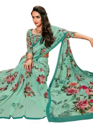 Truly A Pretty Shade In Blue Is Here With This Aqua Blue Colored Saree Paired With Aqua Blue Colored Blouse, This Saree And Blouse Are Fabricated On Georgette Beautified With Contrasting Pink Colored Bold Floral Prints All Over The Saree And Blouse.