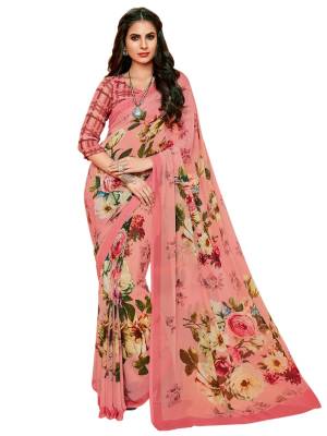 Look Pretty In Pink Wearing This Printed Saree In Pink Color Paired With Pink Colored Blouse, This Saree And Blouse Are Fabricated On Georgette Beautified With Bold Floral Prints All Over The Saree And Checks Print Over The Blouse. 