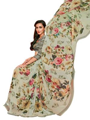 You Will Definitely Earn Lots Of Compliments Wearing this Saree In Grey Color Paired With Grey Colored Blouse, This Saree And Blouse are Fabricated On Georgette Beautified with Bold Floral Prints Over The Saree And Checks Prints All The Pretty Blouse.