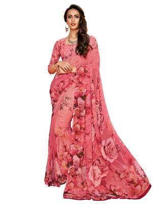 Look Pretty In Pink Wearing This Printed Saree In Pink Color Paired With Pink Colored Blouse, This Saree And Blouse Are Fabricated On Georgette Beautified With Bold Floral Prints All Over The Saree And Blouse. Buy It Now.