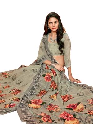 You Will Definitely Earn Lots Of Compliments Wearing this Saree In Grey Color Paired With Grey Colored Blouse, This Saree And Blouse are Fabricated On Georgette Beautified with Bold Floral Prints Over The Saree And Blouse. Buy It Soon Before The Stock Ends.