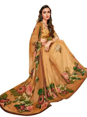 Be It Your Casuals Or Semi-Casual Wear, Grab This Saree In Light Brown Color Paired With Light Brown Colored Blouse. This Saree And Blouse Are Fabricated On Georgette Beautified With Multi Colored Floral Prints All Over It.