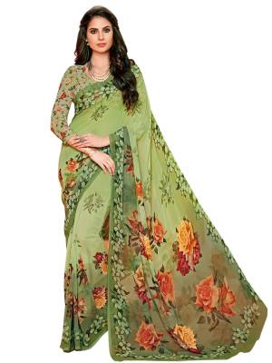 Have A Fresh And Pretty Look Everytime You Wear This Saree In Green Color Paired With Green Colored Blouse. This Saree And Blouse Are Fabricated On Georgette Beautified With Bold Multi Colored Prints All Over It.