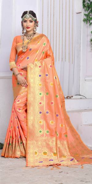 A Must Have Unique Shade In Every Womens Wardrobe, Grab This Silk Saree In Peach Color Paired With Peach Colored Blouse. This Saree And Blouse Are fabricated On Banarasi Art Silk Beautfied With Weave All Over. 