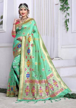 Beautiful Shade In Green IS Here With This Silk Saree In Sea Green Color Paired With Contrasting Dark Pink Colored Blouse. This Saree And Blouse Are Fabricated On Banarasi Art Silk Beautified With Weave All Over It. Buy This Saree Now.