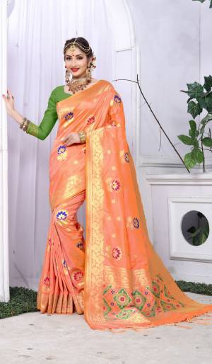 Celebrate This Festive Season Wearing This Designer Silk Saree In Peach Color Paired With Contrasting Green Colored Blouse. This Saree And Blouse Are Fabricated On Banarasi Art Silk Beautified With Weave All Over It.