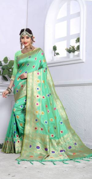 Look Beautiful Wearing This Rich Looking Silk Saree In Sea Green Color Paired With Sea Green Colored Blouse. This Saree And Blouse Are Fabricated On Banarasi Art Silk Beautified With Weave All Over It And Tassels Over The Pallu.