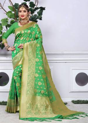 For A Proper Indian Traditional Look, Grab This Silk Saree In Green Color Paired With Green Colored Blouse. This Saree And Blouse Are Fabricated On Banarasi Art Silk Beautified With Weave All Over It. Buy This Banarasi Silk Saree Now.