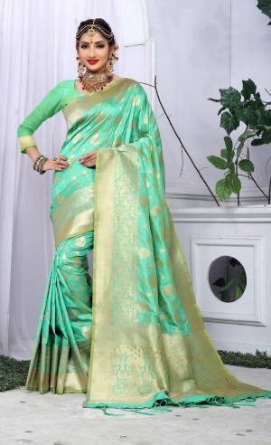 Look Beautiful Wearing This Rich Looking Silk Saree In Light Green Color Paired With Light Green Colored Blouse. This Saree And Blouse Are Fabricated On Banarasi Art Silk Beautified With Weave All Over It And Tassels Over The Pallu.