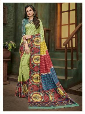 Be It Your Semi-Casual Wear Or Social Gatherings, This Saree Is Suitable For All. Grab This Pretty Saree In Green and Multi Color Paired With Contrasting Blue Colored Blouse, This Saree And Blouse are Fabricated On Cotton Silk Beautified with Prints All Over It.