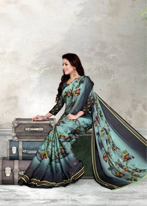 New And Unique Color Pallete Is Here With This Graceful Saree In Aqua Blue And Grey Color Paired With Dark Grey Colored Blouse. This Saree And Blouse Are Fabricated On Chiffon Beautified With Floral Prints. Buy This Saree Now.