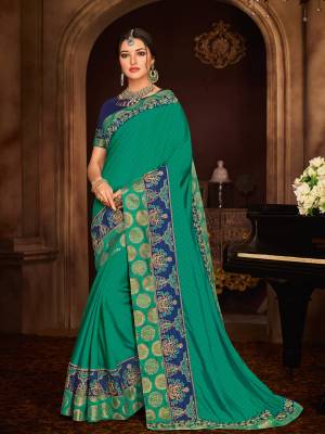 you Look striking and stunning after wearing this Teal green color two tone silk with jacquard butty saree. look gorgeous at an upcoming any occasion wearing the saree. this party wear saree won't fail to impress everyone around you. Its attractive color and designer embroidered design, patch design, stone, designer blouse, beautiful floral design work over the attire & contrast hemline adds to the look. Comes along with a contrast unstitched blouse.