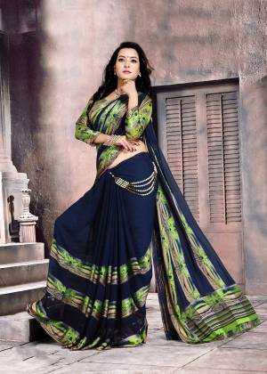 For An Enhanced Personality, Grab This Saree In Navy Blue Color Paired With Green and Blue Colored Blouse. This Saree And Blouse Are Fabricated On Satin Silk Beautified With Printed Pattas. Buy This Saree Now.
