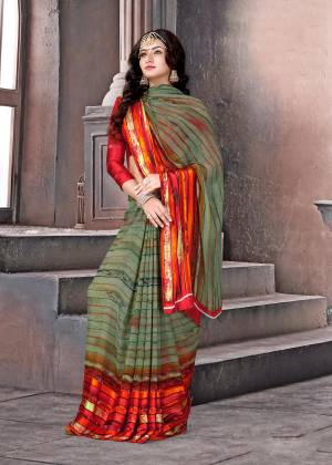Grab This Saree For Your Casual Wear In Olive Green and Red Color Paired With Red Colored Blouse. This Saree And Blouse are Fabricated On Satin Silk Beautified With Beautified With Simple Lining Prints All Over The Saree.