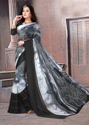 Trendy And Elegant Looking Saree Is Here In Grey And Black Color Paired With Black Colored Blouse. This Saree And Blouse Are Fabricated On Satin Silk Beautified With Abstract Floral Prints. This Saree Is Light Weight And Easy To Carry All Day Long. Buy Now.
