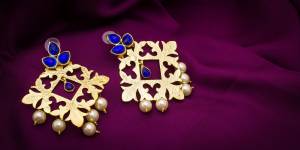 Here Is An Attractive Looking Earrings Set Is Here In Golden color Beautified With Royal Blue Colored Stones And Pearls. It Is Light In Weight And Can Be Paired With Any Heavy Or Light Ethnic Dress.