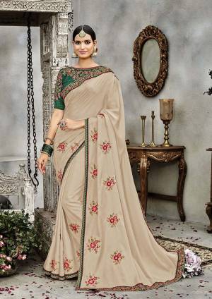 Flaunt Your Rich And Elegant Taste Wearing This Designer Saree In Beige Color Paired With Contrasting Pine Green Colored Blouse. This Saree Is Fabricated On Soft Silk Paired With Art Silk Fabricated Blouse. Buy This Designer Saree Now.