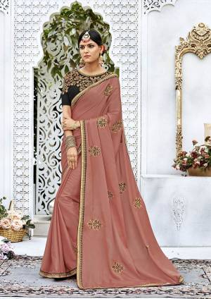 Add This Lovely Shade To Your Wardrobe With This Designer Saree In Dusty Pink Color Paired With Black Colored Blouse. This Saree Is Fabricated On Soft Silk Paired With Art Silk Fabricated Blouse. It Has Attractive Embroidered Blouse And Embroidered Motifs Over The Saree Which Will Earn You Lots Of Compliments From Onlookers.