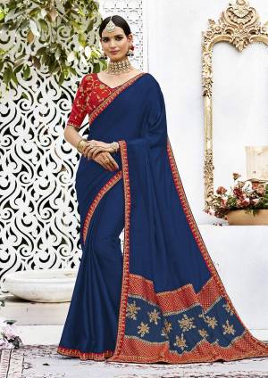 Simple And Elegant Looking Designer Saree Is Here In Dark Blue Color Paired With Contrasting Red Colored Blouse. This Saree Is Fabricated On Soft Silk Paired With Art Silk Fabricated Blouse. This Saree Is Easy To Drape And Carry All Day Long. 