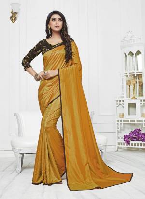 Celebrate This Festive Season Wearing This Saree In Musturd Yellow Color Paired With Contrasting Brown Colored Blouse. This Saree Is Fabricated On Satin Silk Paired With Art Silk Blouse. Its Blouse Is Beautified With Embroidery. Buy Now.