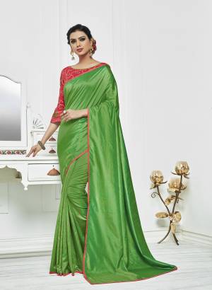 Add This Semi-Casual Wear Saree To Your Wardrobe In Green Color Paired With Contrasting Dark Peach Colored Blouse. This Saree Is Fabricated On Satin Silk Paired With Art Silk Fabricated Blouse. It Is Easy To Drape And Carry All Day Long.