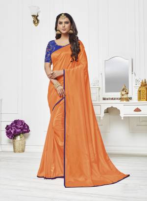 Orange Color Induces Perfect Summery Appeal To Any Outfit, So Grab This Saree In Orange Color Paired With Contrasting Blue Colored Blouse. This Saree Is Fabricated On Satin Silk Paired With Art Silk Fabricated Blouse. Buy This Attractive Saree Now.