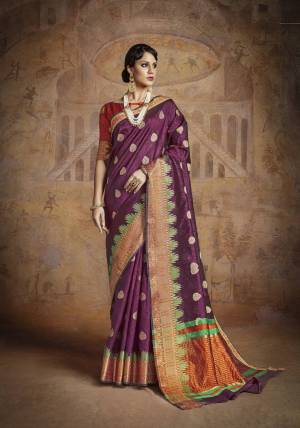 Grab This Attractive Purple Colored Saree Paired With Contrasting Orange Colored Blouse. This Saree And Blouse Are Fabricated On Handloom Art Silk Beautified With Weave All Over. This Saree Is Light Weight And Easy To Carry All Day Long.