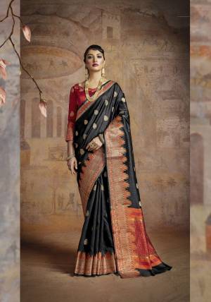 For A Bold And Beautiful Look, Grab This Silk Saree In Black Color Paired With Red Colored Blouse. This Saree And Blouse Are Handloom Art Silk Beautified With Weave. This Evergreen Combination Will Earn You Lots Of Compliments From Onlookers.