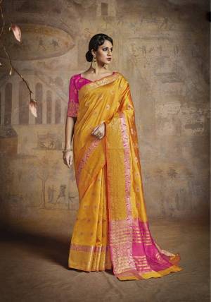 Celebrate This Festive Season With This Bright And Attractive Silk Saree In Yellow Color Paired With Contrasting Fuschia Pink Colored Blouse. This Saree And Blouse Are Fabricated On Handloom Art Silk Beautified With Weave All Over It.