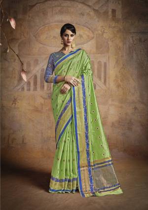 Here Is A Very Pretty Colored Saree In Light Green Paired With Contrasting Light Blue Colored Blouse. This Saree And Blouse Are Fabricated On Handloom Art Silk Beautified With Weave All Over It. Buy This Saree Now.
