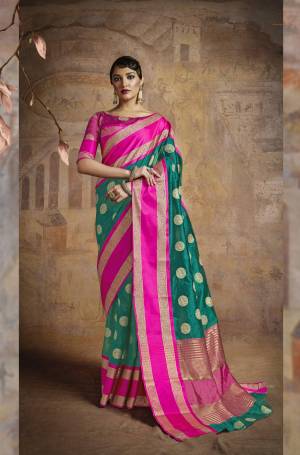 New Shade Is Green Is Here With This Silk Saree In Teal Green Color Paired With Contrasting Fuschia Pink Colored Blouse. This Saree And Blouse Are Fabricated On Handloom Art Silk Beautified With Weave All Over It. Buy This Saree Now.