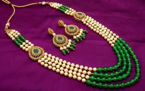 Grab This Beautiful Heavy Necklace Set In Golden And Green Color Beautified With Moti And Stone Work. Pair This Up With Your Silk Saree For An Attractive Look. Buy Now.