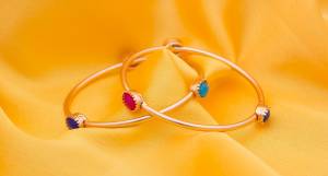 For A Trendy And Young Look, Grab This Very Pretty Delicate Set Of Bangles In Golden Color Beautified With Three Colored Stones. It Is Light Weight And Perfect For Your Daily Wear. Buy Now.