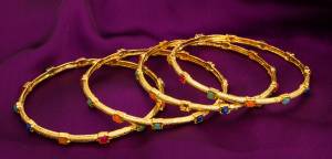 This Lovely Set Of Four Bangles In Golden Color Is Suitable For All Occasion wear, Be It A Party, Wedding Or Festive Wear. This Bangle Set Is In Golden Color Beautified With Multi Colored Stone Work All Over.
