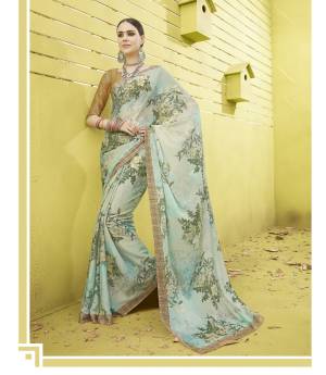 Very Pretty Shade In Blue Is Here With This Lovely Saree In Aqua Blue Color Paired With Beige Colored Blouse. This Saree And Blouse are Fabricated On Cotton Silk Beautified With Bold Floral Prints. This Saree Is Soft Towards Skin And Also It Is Durable.