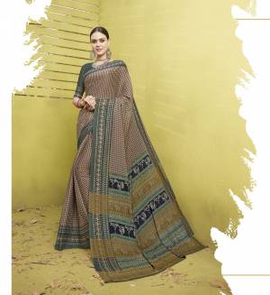 Here Is A Saree For Your Casual Or Semi-Casual Wear In Dusty Pink Color Paired With Grey Colored Blouse. This Saree And Blouse Are Fabricated On Cotton Silk Beautified With Checks Prints All Over The Saree. Its Fabric Ensures Superb Comfort All Day Long.