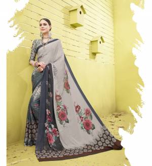 If You Like Bold Prints Than Go For This Pretty Saree In Grey Color Paired With Grey Colored Blouse. This Saree And Blouse Are Fabricated On cotton Silk Beautified with Bold Floral Prints. It Is Light Weight And Easy To Carry All Day Long.