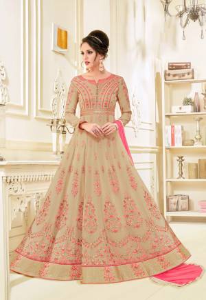 Flaunt Your Rich And Elegant Taste Wearing This Designer Floor Length Suit In Beige Color Paired With Pink Colored Bottom And Dupatta. Its Top Is Fabricated On Georgette Paired With Santoon Bottom And Chiffon Dupatta.It Is Beautified With Heavy Embroidery. Buy This Semi-Stitched Suit Now.