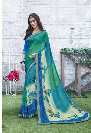 For Your Casual Wear, Grab This Saree In Green and Blue Color Paired With Blue Colored Blouse. This Saree And Blouse Are Fabricated On Georgette Beautified With Prints. Buy This Saree Now.
