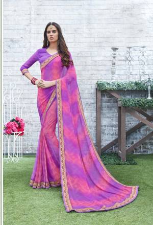 A Must Have Shade In Every Womens Wardrobe Is Here With This Saree In Pink And Purple Color Paired With Purple Colored Blouse. This Saree And Blouse Are Fabricated On Georgette Beautified with Prints All Over It And Lace Border.