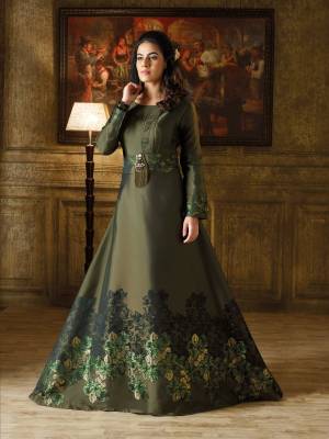 New And Unique Shade In Green Is Here With This Designer Floor Length Gown In Forest Green Color Based On Imported Fabric. It Has Lovely Self Prints And A Broach Over The Belt. 